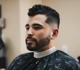 A man with a fade haircut looking to the left